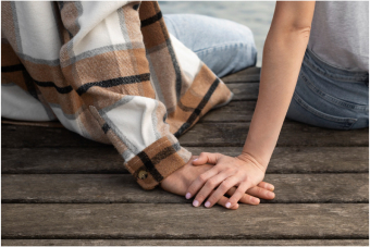 two persons holding hands