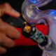 Inhalant Abuse: Causes, Risks, and Social Factors 94 Why Are Inhalants Widely Abused featured image with a person using an inhalent
