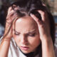Sobriety Fatigue: Symptoms, Causes, and Recovery Tips 95 How to Manage Sobriety Fatigue featured image with a frowning woman holding her head