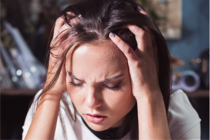 How to Manage Sobriety Fatigue featured image with a frowning woman holding her head