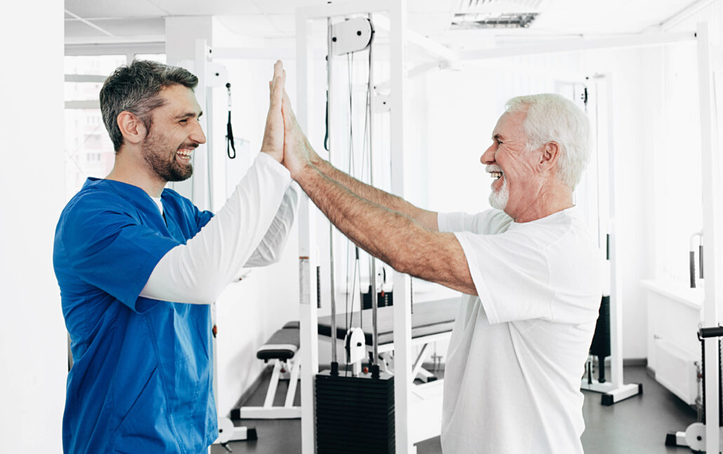 senior man and physical therapist have five after 2025 09 14 15 02 16 utc
